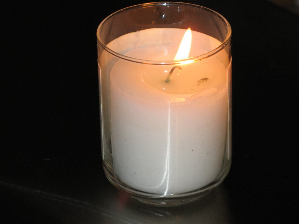 A lit memorial candle